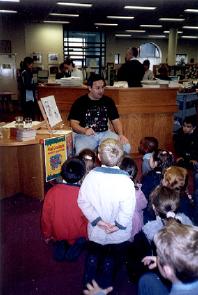 Oisín telling a story in a library.